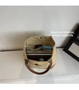 Interior espacioso del bolso tote de lona beige con asas de cuero marrón y cierre magnético