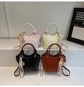 Detail view of retro bucket bags in four colors with embossed bear patterns and tassels
