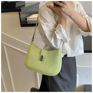 Detail of light green leather half-moon bag with dark gray metallic push-lock closure