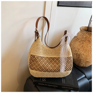 Detail of straw shoulder bag with hollow mesh design and white lace ribbon decoration