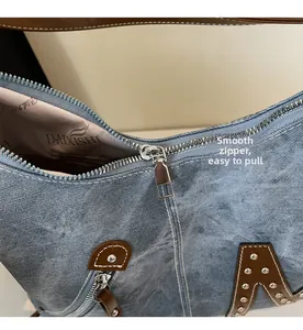 Close-up of smooth metal zipper and denim texture on large tote bag detail