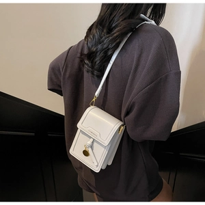 Detail of white textured leather crossbody phone bag with Luomeinisha logo and gold hardware