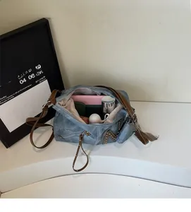 Top view of blue canvas tote bag showing spacious interior with phone and water bottle
