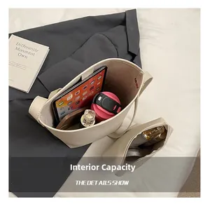 Large cream pebbled leather bucket bag interior view with a matching zipper pouch