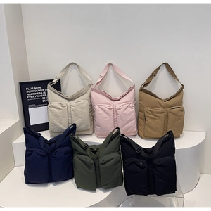 Detailed view of large canvas messenger bags in six colors with dual front zipper pockets