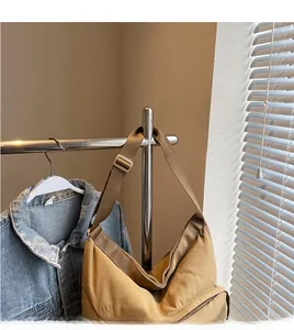 Detail of the khaki large tote bag featuring an adjustable smooth wide shoulder strap