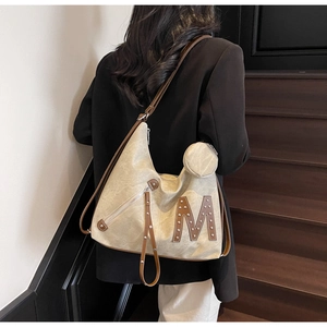 Detail of multi-functional tote bag with M logo patch and detachable round coin purse