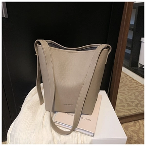 Detail of apricot bucket bag featuring high-quality lychee grain leather texture