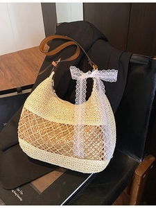 Summer woven straw shoulder bag with leather straps and a delicate white lace bow detail