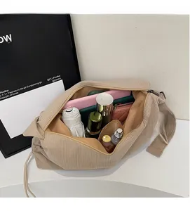 Top-down view of spacious corduroy shoulder bag showing ample internal storage space