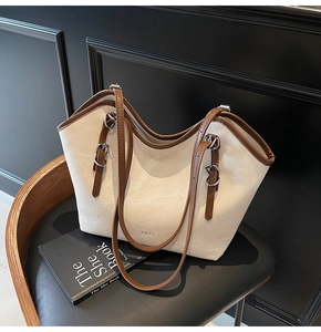 Detail shot of vintage tote bag showing retro beige matte texture and brown leather trim