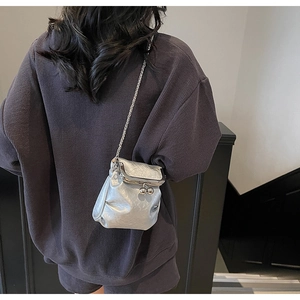 Silver metallic crossbody bag with textured wrinkles and elegant metal chain strap