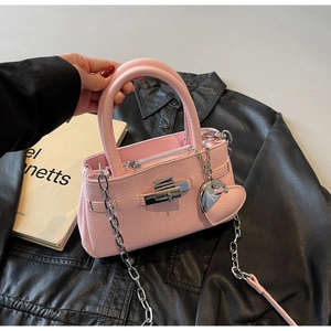 Detailed view of pink pebble grain leather bucket bag with silver lock and heart charm