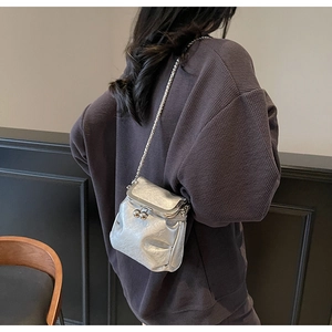 Silver metallic chain crossbody bag shown on a model for a stylish lifestyle look