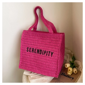 Detail of hot pink woven tote bag with Serendipity text and rustic summer decor
