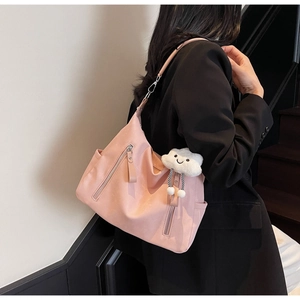 Détail du sac cabas en nylon rose avec fermetures éclair argentées et un charmant nuage
