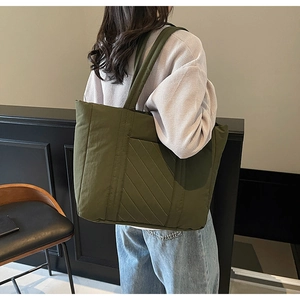 Olive green quilted canvas tote bag with padded shoulder straps for daily use
