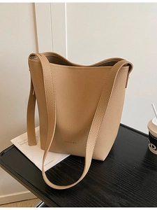 Khaki pebbled leather bucket bag with top handle and shoulder strap for daily use