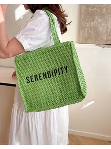 Green woven tote bag with Serendipity text for beach vacations and summer style