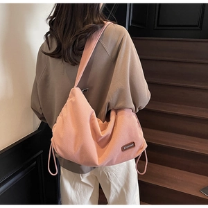 Detail of pink corduroy shoulder bag showing soft texture and Ziyouse leather patch