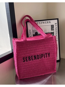 Fuchsia woven tote bag with Serendipity print and zipper closure on a table