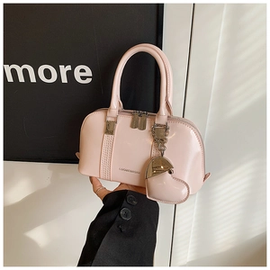 Pink patent leather shell bag with heart charm and silver hardware detail