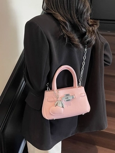 Pink lychee grain leather bucket bag with silver chain strap and heart charm
