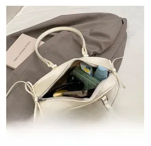 Interior view showing the large capacity and storage space of the cream baguette bag