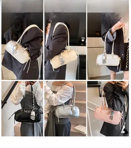 Detail view of stylish underarm baguette bags with D pendant in four metallic colors