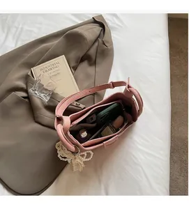 Interior view of pink bucket bag with pearls showing space for phone and perfume