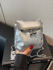 Mini silver metallic chain bag with vintage kiss-lock closure and dual top spheres