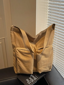 Lightweight khaki nylon tote bag with large front zip pockets in a stylish casual design