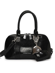 Glossy black shell handbag with a heart charm and detachable shoulder strap for women
