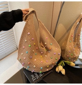 Detail of beige hollow woven tote bag with colorful beads and wide shoulder strap