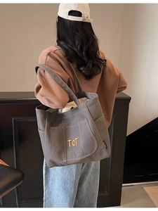 Large gray canvas tote bag with front pockets and TCT embroidery for daily commute