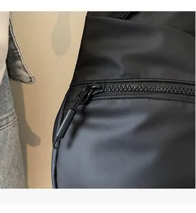 Macro detail of high-quality smooth plastic zipper and woven puller on a black tote bag