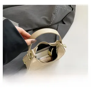 Detailansicht der cremefarbenen Hobo-Bag mit Krokoprägung und Platz für Kosmetikartikel