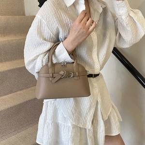 Detail of khaki lychee grain leather handbag with buckle strap and smooth zipper