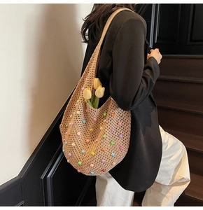 Detail of hand-woven crochet tote bag featuring vibrant multicolored beads and hollow texture
