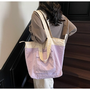 Detailed shot of large capacity color-block tote bag with front pocket and handles
