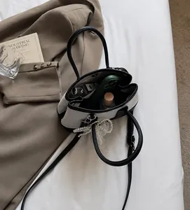 Internal view of the stylish contrast handbag showing space for phone and perfume