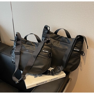 Detail of black sports tote bag showing durable nylon texture and adjustable strap