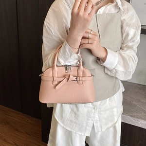 Pink litchi texture handbag with belt buckle detail and metal zipper closure