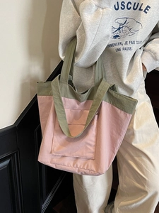 Fashionable pink and olive green large tote bag with front pocket for casual commute