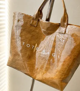 Close-up of brown paper texture tote bag with waterproof clear PVC outer layer and text