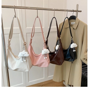 Variety of minimalist Hobo shoulder bags with plush cloud charms in four classic colors