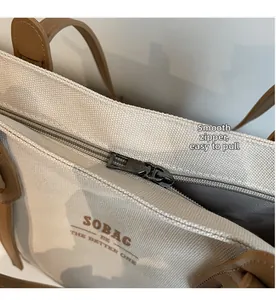 Close-up of smooth metal zipper and thick canvas fabric on a stylish tote bag