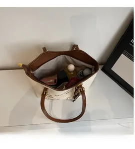 Interior view of canvas tote bag with zipper closure showing daily essentials storage