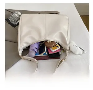 Interior view showing spacious capacity of the cream tote bag with daily essentials