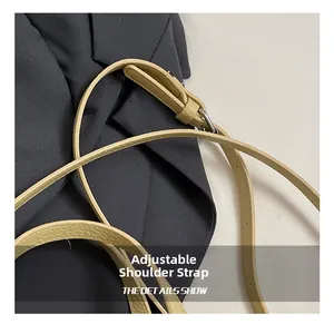 Detail of adjustable litchi texture leather strap with silver metal buckle on bucket bag